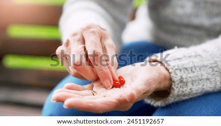 Person, hand and pill bottle for prescription tablet or life extension drugs, anti aging or medication. Fingers, outdoor and park with multivitamin or iron supplements for anemia, magnesium or pain Royalty-Free Stock Photo #2451192657