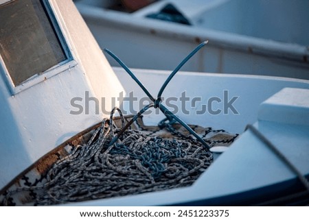 Detail of fishing boat with anchor and rope. Selective focus.