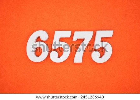 Orange felt is the background. The numbers 6575 are made from white painted wood.