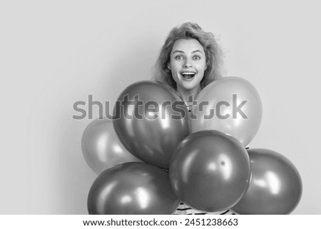 happy birthday girl hold balloons in studio. amazed girl with balloon for birthday party isolated on yellow background. birthday party girl