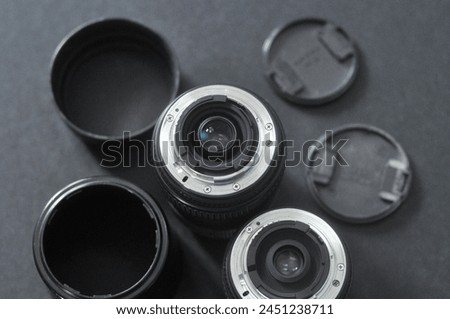 Group of camara lenses with its parts. Royalty-Free Stock Photo #2451238711