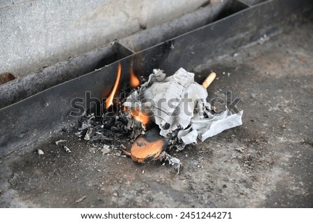Bi'ur chametz - Burning Chametz (foods  with leavening agents) and and wooden spoon on the morning before Passover Jewish holiday. Chametz food are forbidden to Jews on the holiday of Passover. Royalty-Free Stock Photo #2451244271