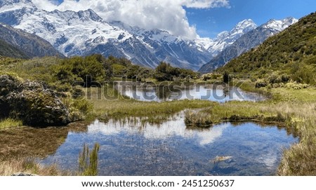 Hill top views of Aoraki Mount Cook reflecting in water at Red Tarns, Mount Cook National Park, New Zealand  Royalty-Free Stock Photo #2451250637