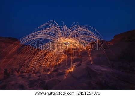 Burning steel wool fireworks, the grand canyon of Thailand (3000 bok) at Sam Pan Bok, Mekong River, Ubon Ratchathani, Thailand. Royalty-Free Stock Photo #2451257093
