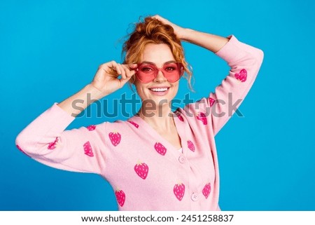 Photo portrait of lovely young lady hold hair sunglass dressed stylish pink clothes isolated on blue color background