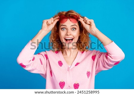 Photo portrait of lovely young lady take off sunglass amazed dressed stylish pink clothes isolated on blue color background