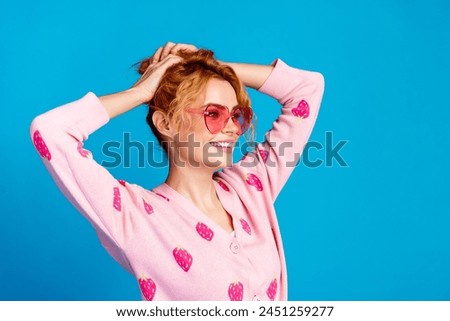 Photo portrait of attractive young woman hold hair sunglass summer vacation dressed stylish pink clothes isolated on blue color background