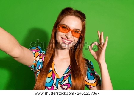 Photo of pretty young woman make selfie show okey symbol wear top isolated on bright green color background