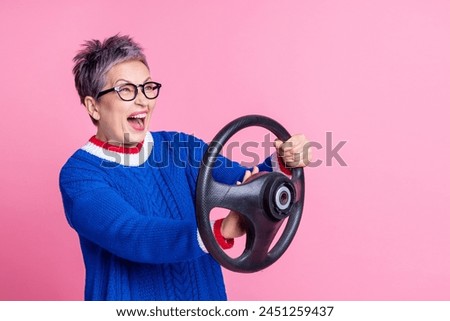 Photo of positive crazy funny woman wear trendy clothes hold steering wheel drive fast empty space isolated on pink color background