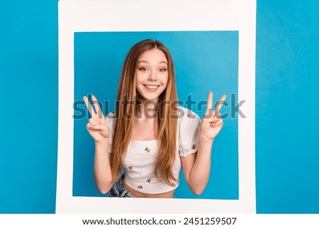 Photo of nice young girl show v-sign paper window wear top isolated on blue color background