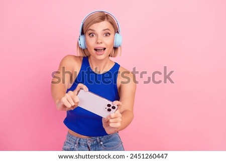 Photo of pretty young woman smart phone play game wear blue top isolated on pink color background