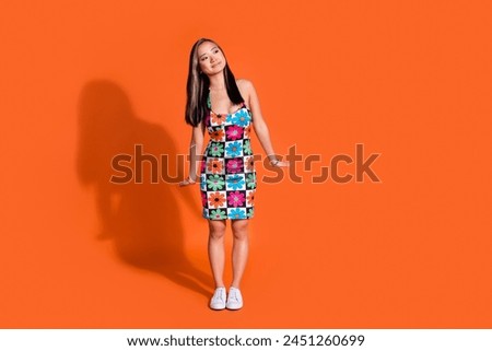 Full length photo of cheerful nice woman dressed flower print clothes look at discount empty space isolated on orange color background