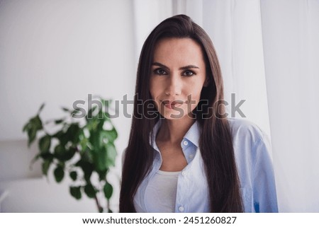 Photo of nice lady smile good mood look camera wear blue shirt bright interior flat indoors