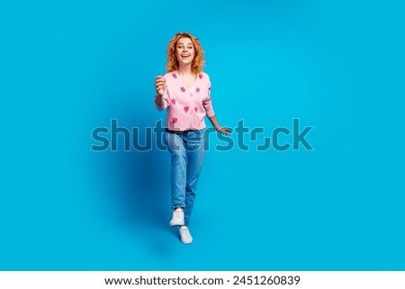 Full length photo of lovely young lady walking running dressed stylish pink clothes isolated on blue color background