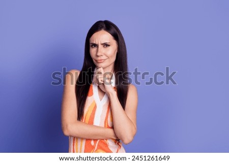 Photo of suspicious doubtful lady wear dress arm chin emtpy space isolated purple color background Royalty-Free Stock Photo #2451261649