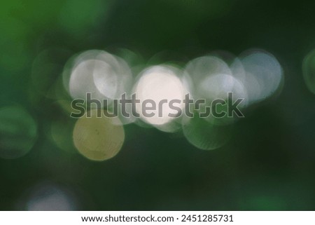 Circular bokeh isolated on a green background, image for mobile phone screen, display, wallpaper, screensaver, lock screen and home screen or background
