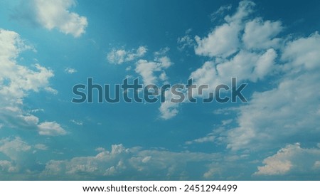 Sky With Beautiful Silky Altocumulus Clouds Creates A Parallax Effect. High Angle View Of Approaching Wispy Clouds And Blue Sky. Royalty-Free Stock Photo #2451294499