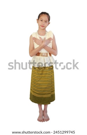 Smiling Asian girl in traditional Thai costume dress with making love gesture on white background. Image with clipping path and full length.