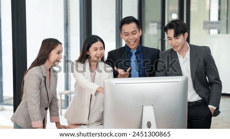 Business associates discussing over laptop computer in office. Casual business meeting. Communication and technology concept