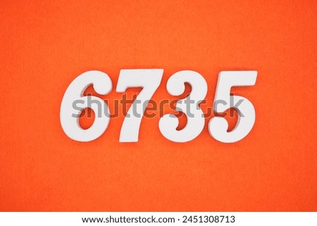 Orange felt is the background. The numbers 6735 are made from white painted wood.
