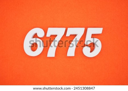Orange felt is the background. The numbers 6775 are made from white painted wood.