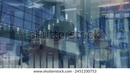 Image of financial data over caucasian woman using vr headset in office. business, finance, technology and digital interface digitally generated image.