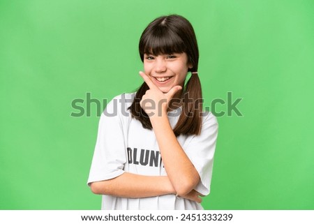 Little volunteer girl over isolated background happy and smiling