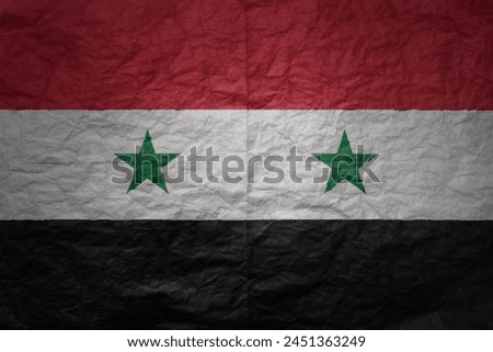 colorful big national flag of syria on a grunge old paper texture background