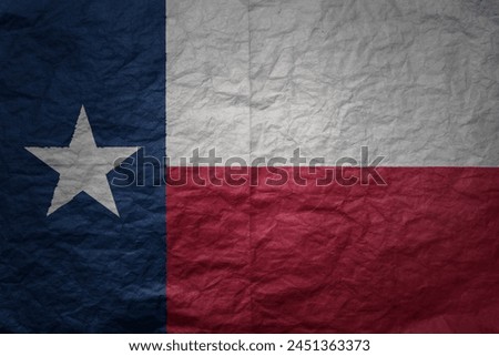colorful big national flag of texas state on a grunge old paper texture background