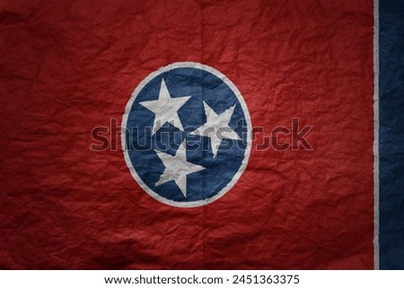 colorful big national flag of tennessee state on a grunge old paper texture background
