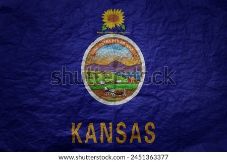 colorful big national flag of kansas state on a grunge old paper texture background