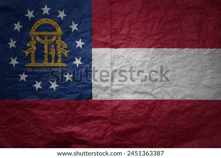 colorful big national flag of georgia state on a grunge old paper texture background
