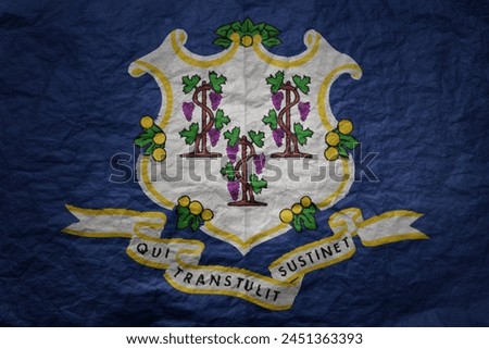 colorful big national flag of connecticut state on a grunge old paper texture background