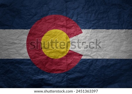 colorful big national flag of colorado state on a grunge old paper texture background