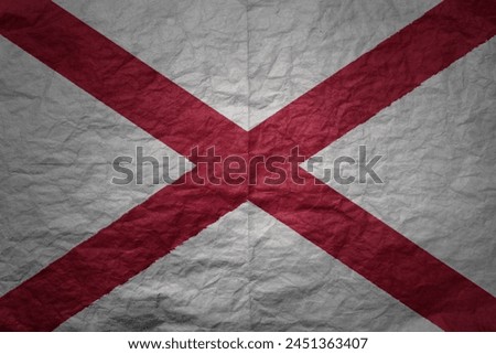 colorful big national flag of alabama state on a grunge old paper texture background