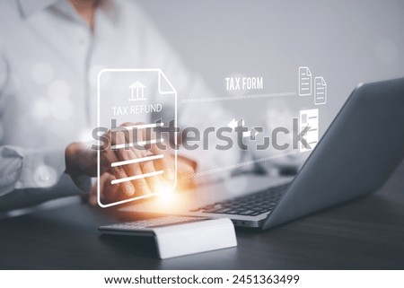 Man using a laptop with TAX REFUND and refund tax of duty taxation business, graphs and chart being demonstrated on the screen media,  tablet pc and selecting tax refund, Saving tax for business