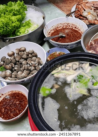 a photography of a table with bowls of food and bowls of soup.