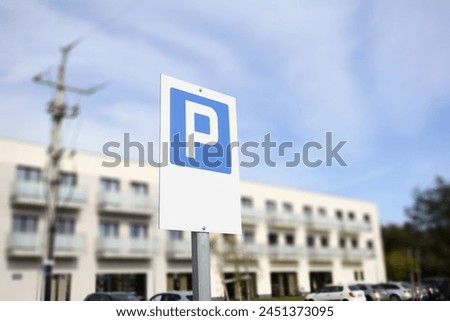 A parking sign displayed in front of a building entrance.