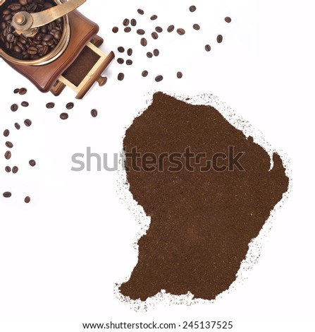Coffee powder in the shape of French Guiana and a decorative coffee mill.(series)