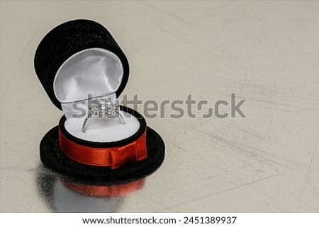 Ring in a jewelry box on background of steel plate for texture and wallpaper