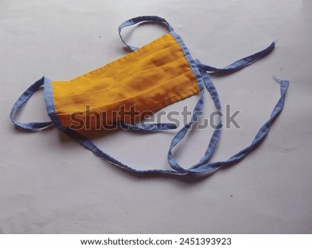 The mask texture is made of simple cloth with orange, blue edges and a white background