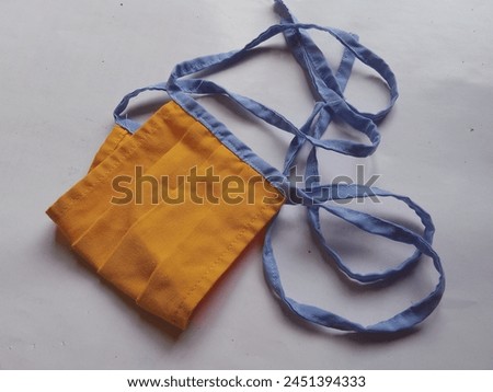 The mask texture is made of simple cloth with orange, blue edges and a white background