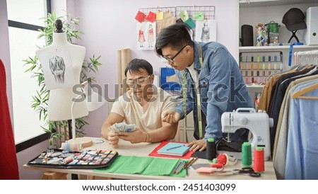 Two men counting chinese yuan in a tailor shop, surrounded by design sketches and a sewing machine