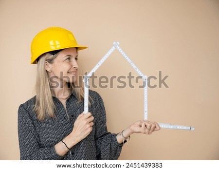 woman, architect, technician, builder, polisher with yellow safety hat and yellow folding rule in front of brown background Royalty-Free Stock Photo #2451439383