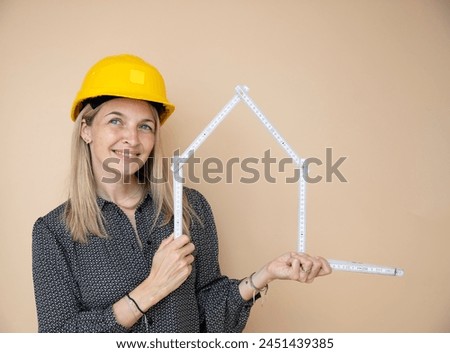 woman, architect, technician, builder, polisher with yellow safety hat and yellow folding rule in front of brown background Royalty-Free Stock Photo #2451439385