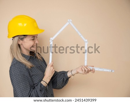 woman, architect, technician, builder, polisher with yellow safety hat and yellow folding rule in front of brown background Royalty-Free Stock Photo #2451439399