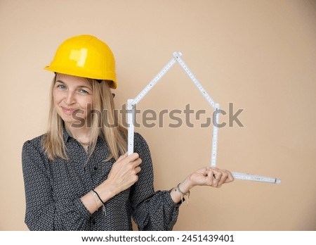 woman, architect, technician, builder, polisher with yellow safety hat and yellow folding rule in front of brown background Royalty-Free Stock Photo #2451439401