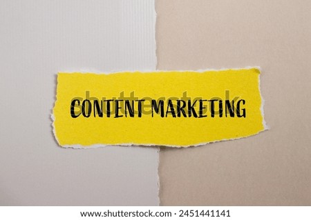 Content marketing words written on ripped yellow paper piece with paper background. Conceptual content marketing symbol. Copy space.