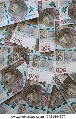 Polish 500 zloty banknotes scattered on the desk