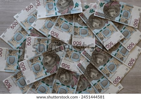 Polish 500 zloty banknotes scattered on the desk
